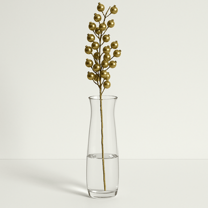 Gold Berry Stem 65cm with metallic gold berries and delicate branches, displayed in a clear glass vase against a white background.