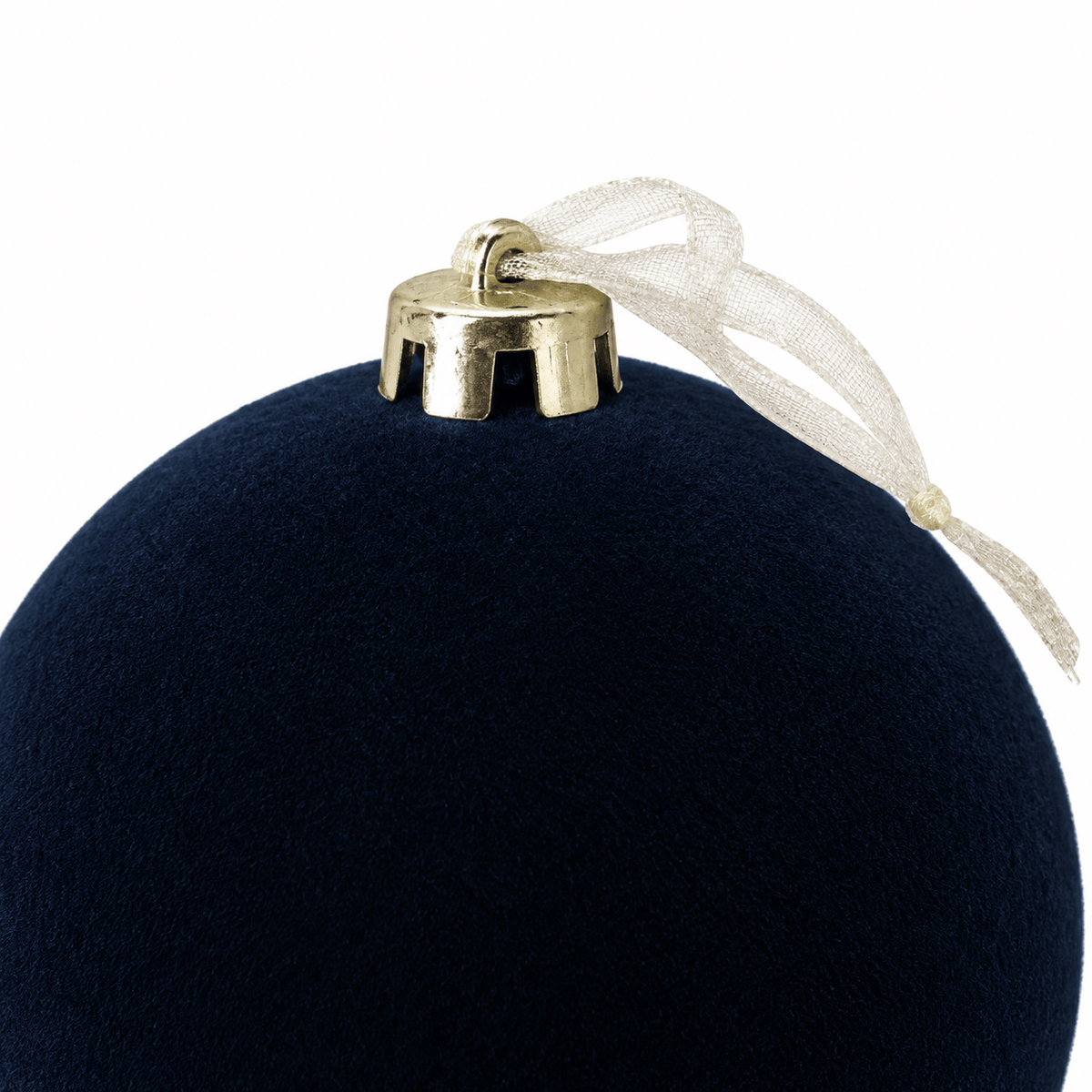 Close-up of blue velvet Christmas bauble showcasing its soft navy velvet texture, metallic gold hanging cap and delicate sheer ribbon loop.