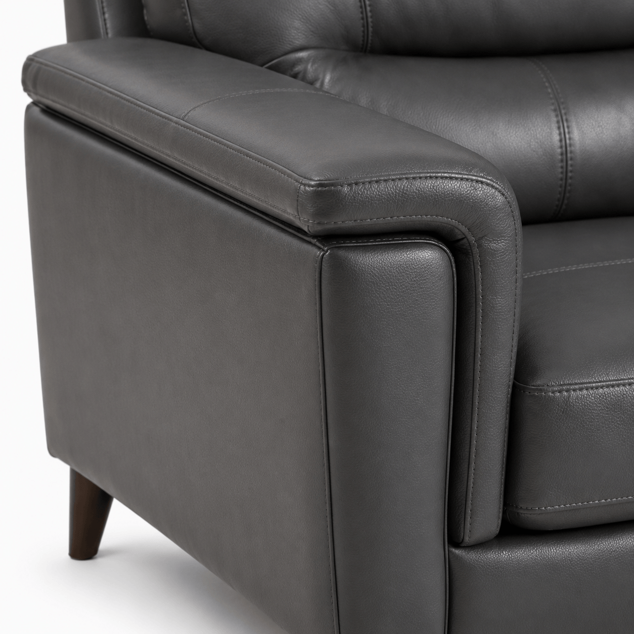 Compton Armchair padded arm close up, grey leather upholstery detail, modern living room chair