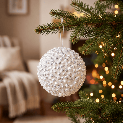 Foam Cluster Bauble - White Glitter - 15cm, hanging on a Christmas tree with warm white fairy lights, featuring sparkling white clusters and iridescent glitter detailing.