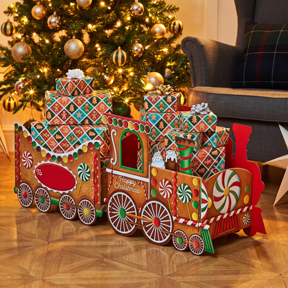Large Gingerbread Christmas Train Gift Box displayed beside decorated Christmas tree