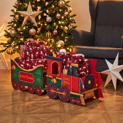 Large Santa Christmas Train Gift Box - Red displayed beside decorated Christmas tree
