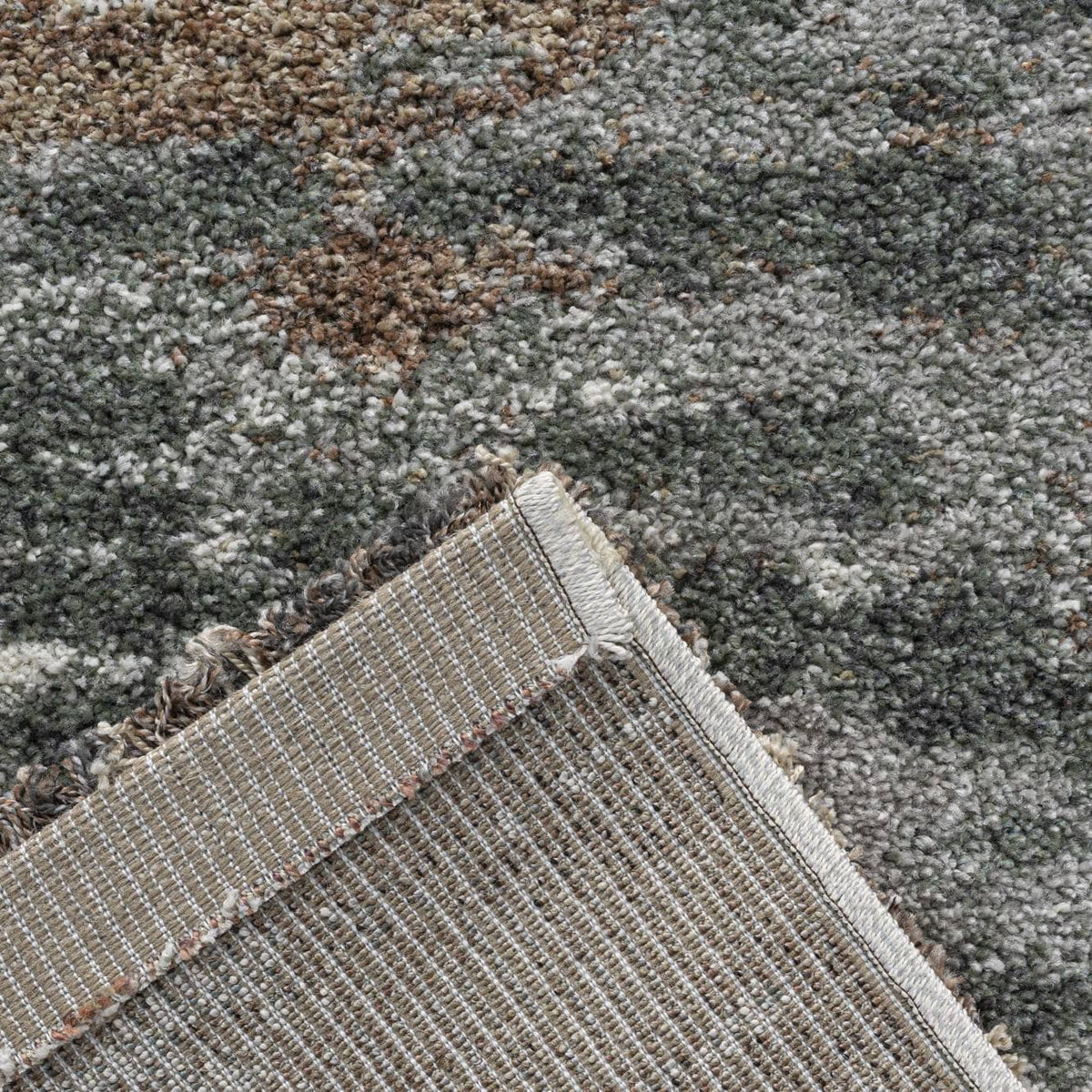 Mehari Green Cloud Rug close-up showing textured green grey cream and brown rug design