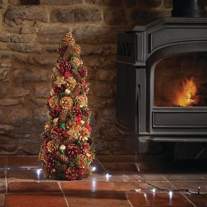 Three Kings Christmas Cone 45cm pinecone Christmas tree decoration styled beside fireplace. 