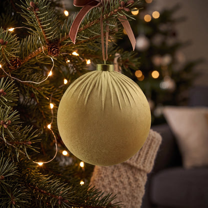 Velvet Bauble – Taupe – 15cm, hanging on a Christmas tree with warm fairy lights, featuring soft taupe velvet fabric and elegant gathered detailing.