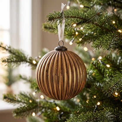 Vintage Matte Gold Fluted Bauble - 15cm hanging on a festive Christmas tree, featuring antique gold ribbed detailing surrounded by warm white fairy lights.
