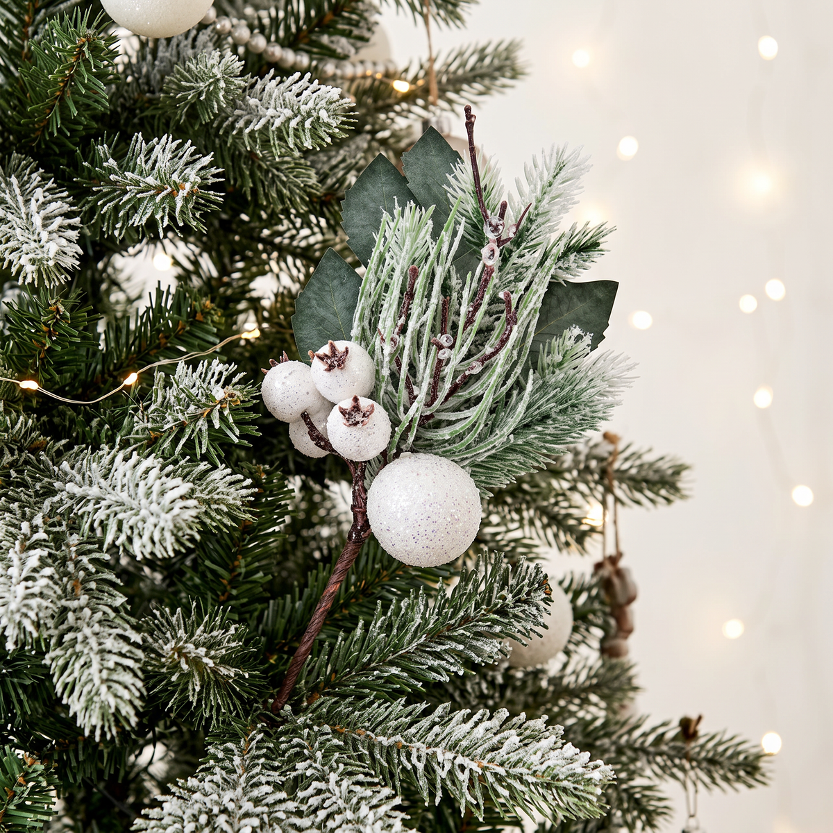 White Fruit Pick 31cm displayed on frosted Christmas tree with white festive decorations