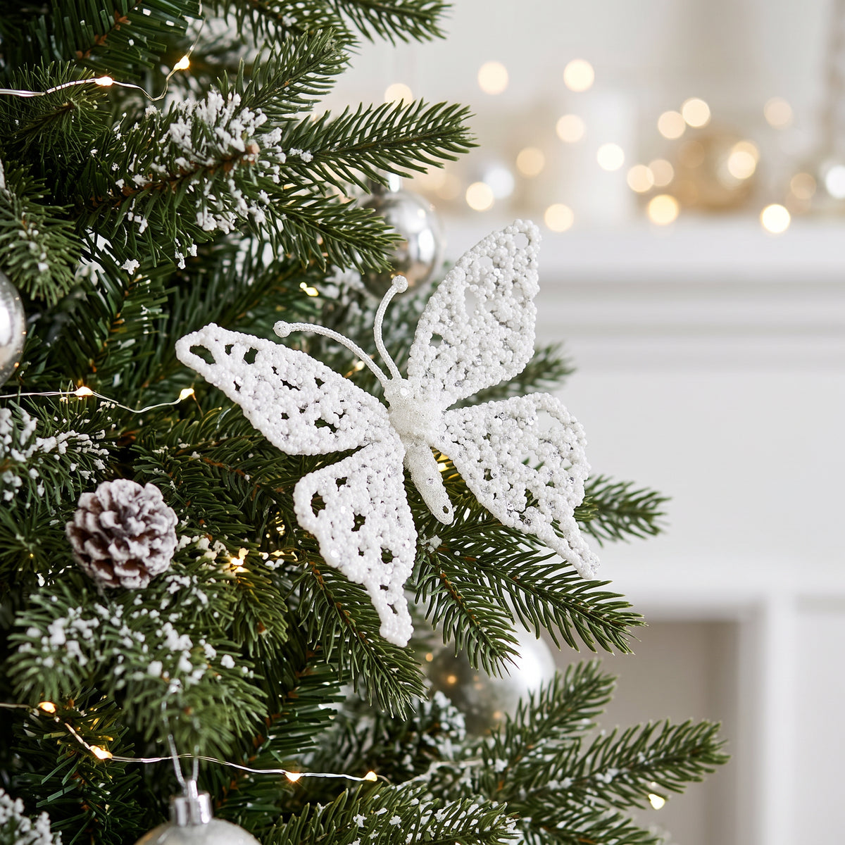 White Glitter Butterfly Clip 18cm displayed on festive Christmas tree